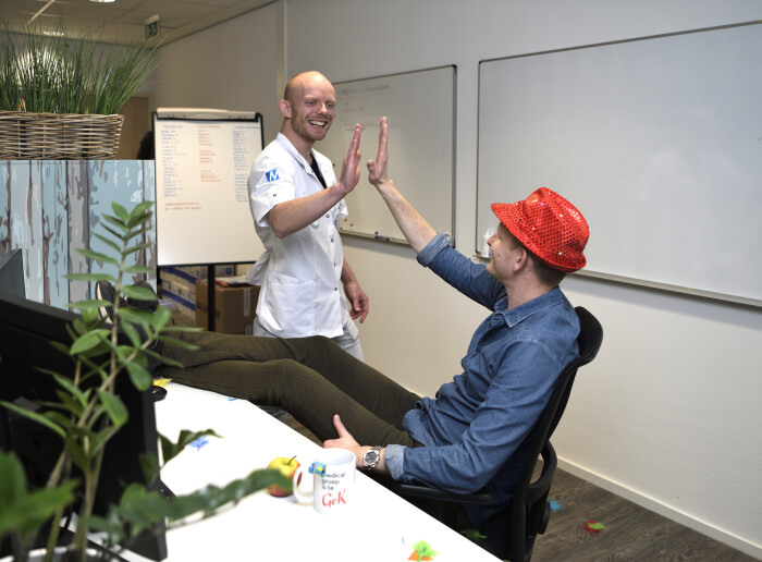 Blije zorgmanager die collega een high five geeft